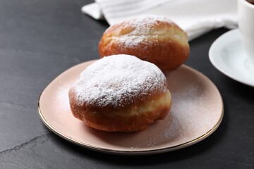 Delicious sweet buns on dark gray table, closeup