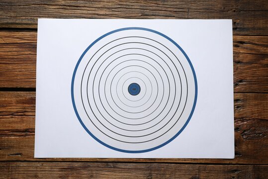 Shooting target on wooden table, top view