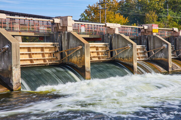 Dynamic Water Flow at Argo Dam with Safety Sign, Huron River, Eye-Level View