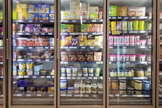 PENANG, MALAYSIA - 1 DEC 2023: Inside Jaya Grocery store in Penang, a vast glass freezer showcases a variety of local and imported ice cream brands.