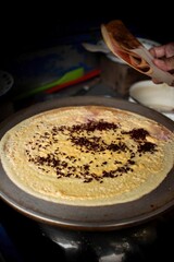 image of sweet crepes covered in sprinkles and chocolate taken at an angle