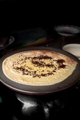 image of sweet crepes covered in sprinkles and chocolate taken at an angle