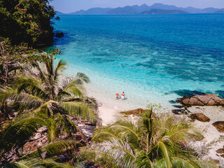 Koh Wai Island Thailand tropical Island near Koh Chang, couple of men and woman on the beach