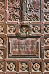 Ornate Bronze Door Detail with LIGHT Inscription Close-Up
