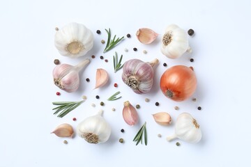 Fresh garlic, onion, rosemary and peppercorns on white background, flat lay