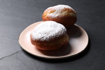 Delicious sweet buns on dark gray table, closeup