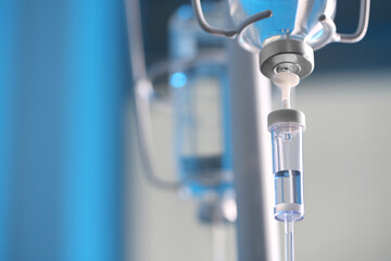 IV drip against blurred background, space for text