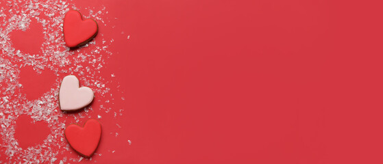 Heart shapes made of snow and sweet cookies on red background with space for text. Valentine's day celebration
