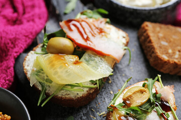 Board with tasty sandwiches, closeup