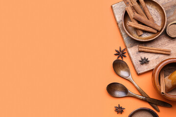 Composition with cinnamon sticks, powder and anise stars on color background