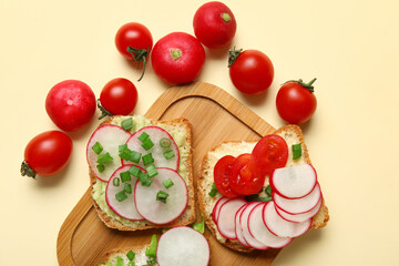 Board with delicious radish bruschettas on beige background