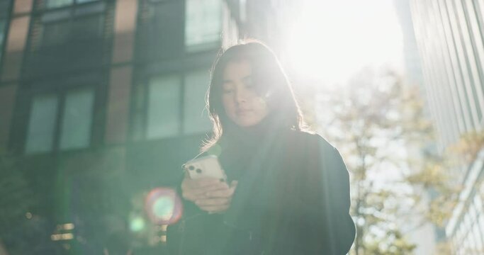 Japanese Woman, Typing And Smartphone In City For Connection And Technology Or Wellness By Outdoor. Young Person, Message Or Cellphone In Tokyo On Social Media, Communication Or Online In Urban Town