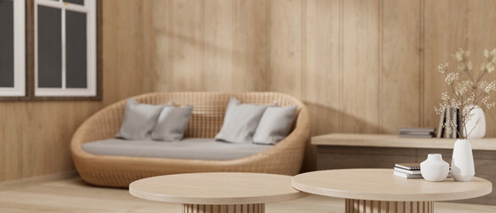 Copy space on a wooden coffee table in a cosy, Scandinavian living room. blurred background.