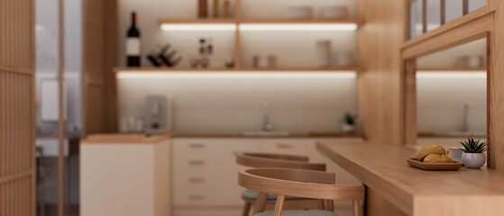 Side view of a beautiful Scandinavian kitchen with a wooden dining table. Domestic dining room