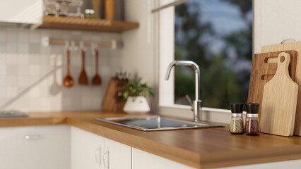 Close-up image of a sink on a wooden kitchen counter in a modern, Scandinavian kitchen.