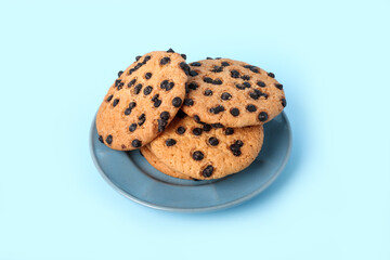 Plate with cookies on blue background