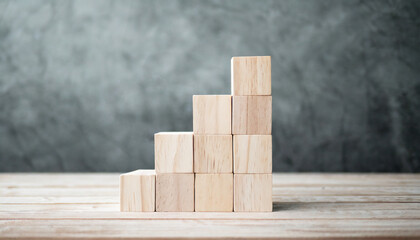 Neatly stacked wooden cubes on table with space for text/infographics symbolize organization, creativity, and customizable information display in a stock photo