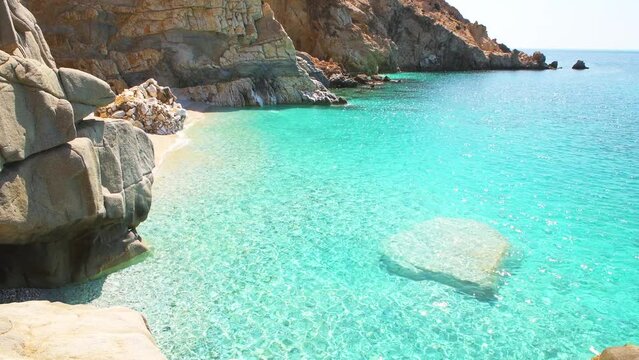 Seychelles beach at Magganitis, Ikaria island Greece, Icarian sea with crystal clear green turquoise water rocky cliffs coast high angle view