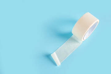 Adhesive tape roll on blue background