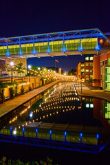 Fototapeta na wymiar Indianapolis Urban Nightscape Illuminated Pedestrian Bridge and Canal Reflections
