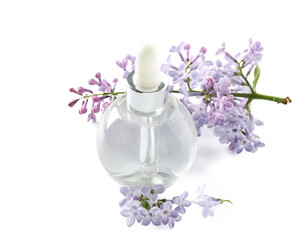 Obraz na płótnie Canvas Bottle of cosmetic oil with beautiful lilac flowers on white background