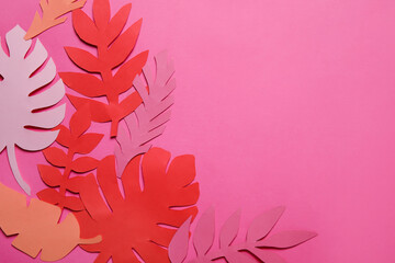 Fototapeta na wymiar Different paper tropical leaves on pink background