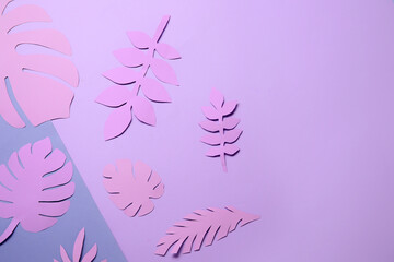 Fototapeta na wymiar Beautiful origami leaves on purple background