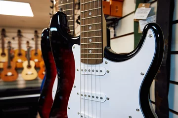 Afwasbaar Fotobehang Muziekwinkel Electric guitar in a music shop. Close-up of electric guitar