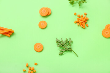 Obraz na płótnie Canvas Slices of fresh carrots green background