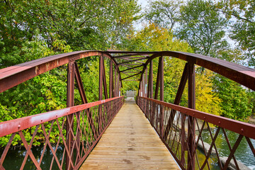 Fototapeta na wymiar Rustic Red Truss Bridge with Autumn Foliage in Rural Indiana