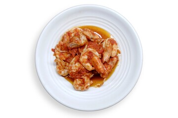 Schezwan Prawns in white plate with wooden background. Schezwan Prawns is indo-chinese cuisine curry dish with prawns or shrimps roasted in Schezwan Sauce. Udang saos Padang 