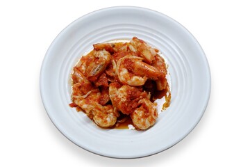 Schezwan Prawns in white plate with wooden background. Schezwan Prawns is indo-chinese cuisine curry dish with prawns or shrimps roasted in Schezwan Sauce. Udang saos Padang 