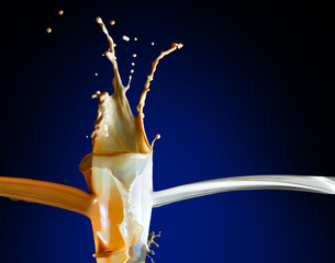 Milk coffee splashes from the class on the blue background - 706153782