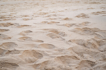 Many pits on sand, Caused by people's footprint
