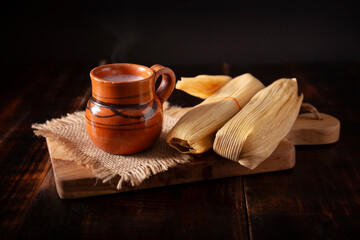 Tamales. hispanic dish typical of Mexico and some Latin American countries. Corn dough wrapped in corn leaves. The tamales are steamed.