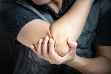 	
A man has pain in his elbow and tendon muscles and he relieves the pain with a massage. Health...