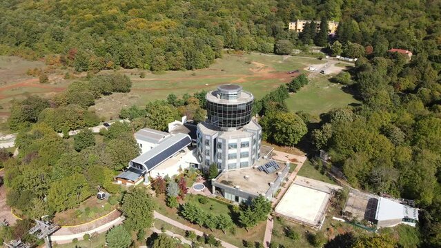 Slow motion drone shot of Dajti mountain cable car office reveals Tirana valley and city landscape, Albania, Europe