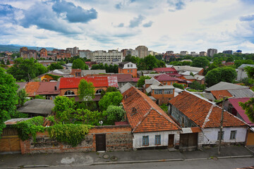 Fototapeta na wymiar Red roofs of the residential buildings in Vladikavkaz city