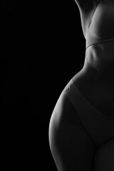 Naklejka premium Silhouette of attractive young woman in underwear on dark background, closeup
