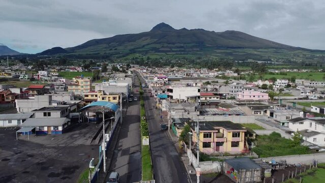 El Corazón volcano overlooks Aloasi Ecuador drone shot reveal town entrance