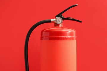 Fire extinguisher on red background