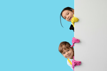 Cute little janitors with blank poster on blue background. Opposite Day celebration