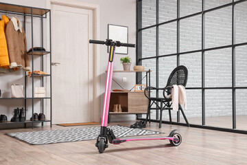 Pink electric scooter in interior of stylish hall