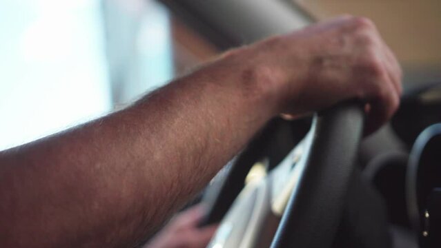 Hands on passenger car steering wheel left turn
