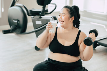 Fototapeta na wymiar sport healthy fat women happy smiling enjoy drink milk and diet exercise activity in fitness sport club