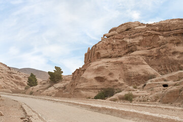 Fototapeta premium The road at beginning of Nabatean Kingdom tourist route in the capital of the Nabatean Kingdom Petra in Wadi Musa city in Jordan