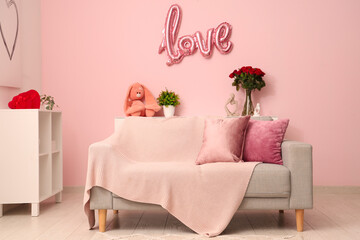 Stylish festive living room with balloon in shape of word LOVE and roses bouquet. Valentine's Day celebration