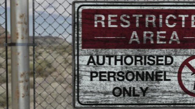 High quality 3D CGI render of a chainlink fence at a high security installation in a desert scene, with a Restricted Area - Authorised Personnel Only sign