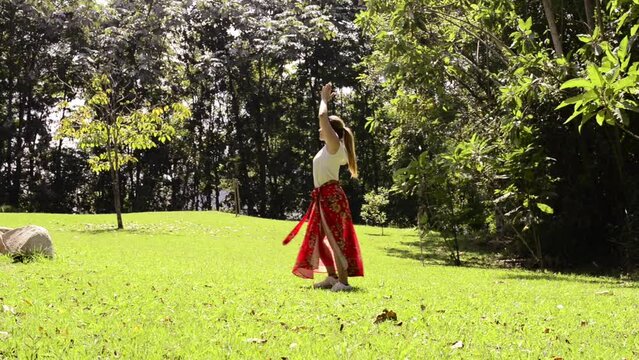 Girl dances and turn in circles in meditation with nature. Outdoor yoga, Tai Chi