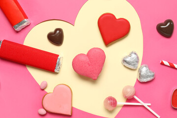 Different tasty sweets and heart-shaped paper cut on yellow background. Valentine's Day celebration